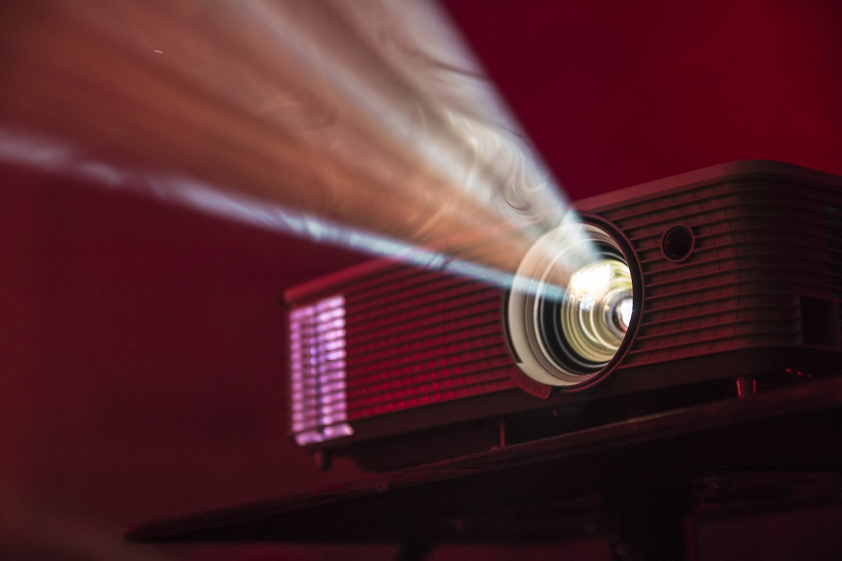سما فيجن Smart 4K Projector cinematic light beams dark room